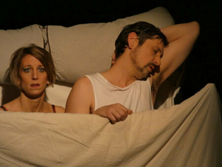Photo of the Kvetch performance by Cie de l'Empreinté. Donna and Frank in the bed.