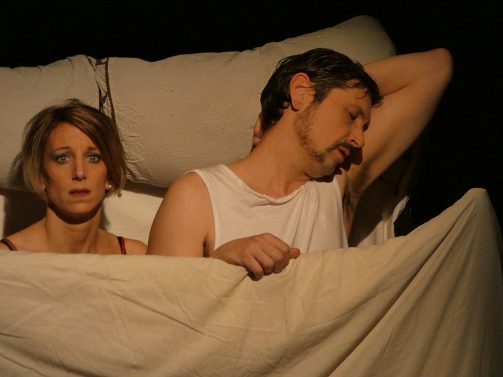 Photo of the Kvetch performance by Cie de l'Empreinté. Donna and Frank in the bed.