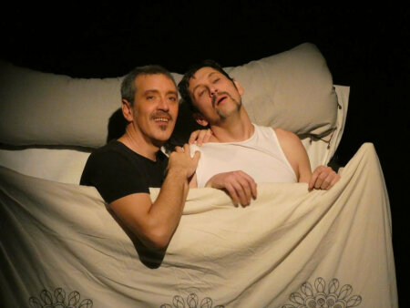 Photo of the Kvetch performance by Cie de l'Empreinté. Hal and Frank in a bed.